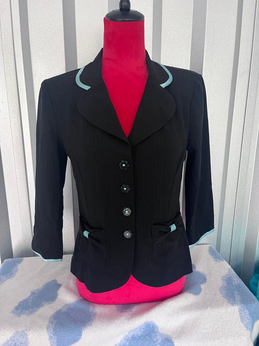 Black and teal blazer with shoulder padding